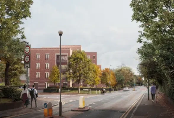 Street view with trees and building, pedestrians walking.