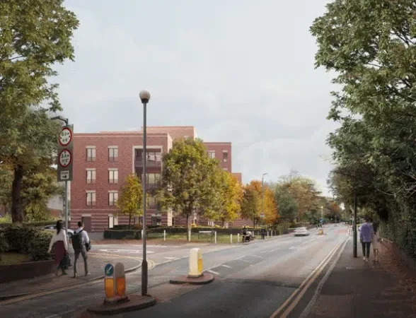 Street view with trees and building, pedestrians walking.