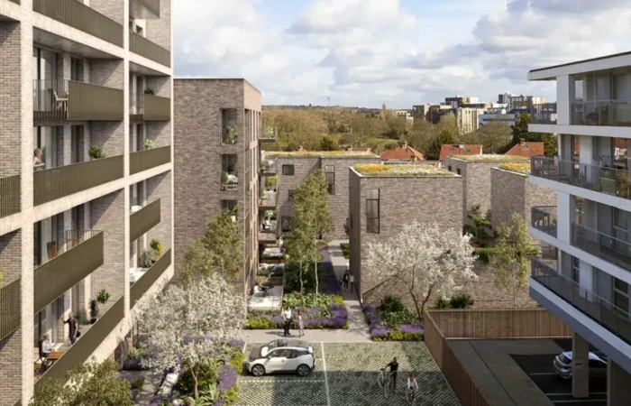Modern apartment complex with courtyard and parked cars.