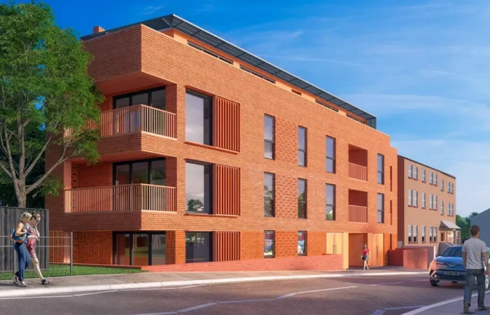 Modern brick residential building with balconies and street view.