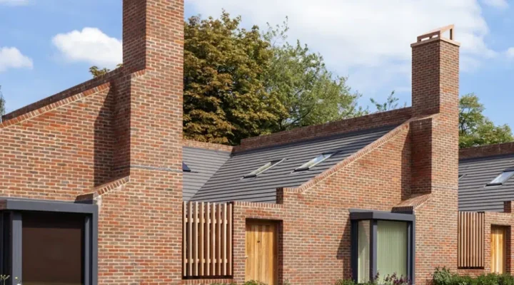 Modern brick houses with distinctive chimneys and skylights.
