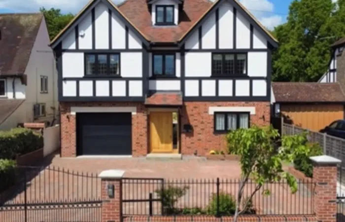 Modern two-storey house with brick and timber facade.