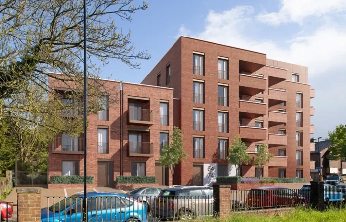 Modern brick apartment building with parked cars.