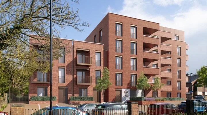Modern brick apartment building with parked cars.