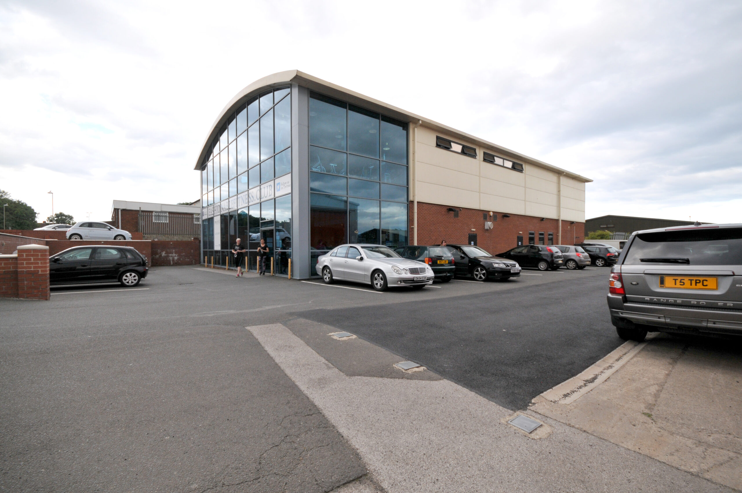 Modern fitness club exterior with car park
