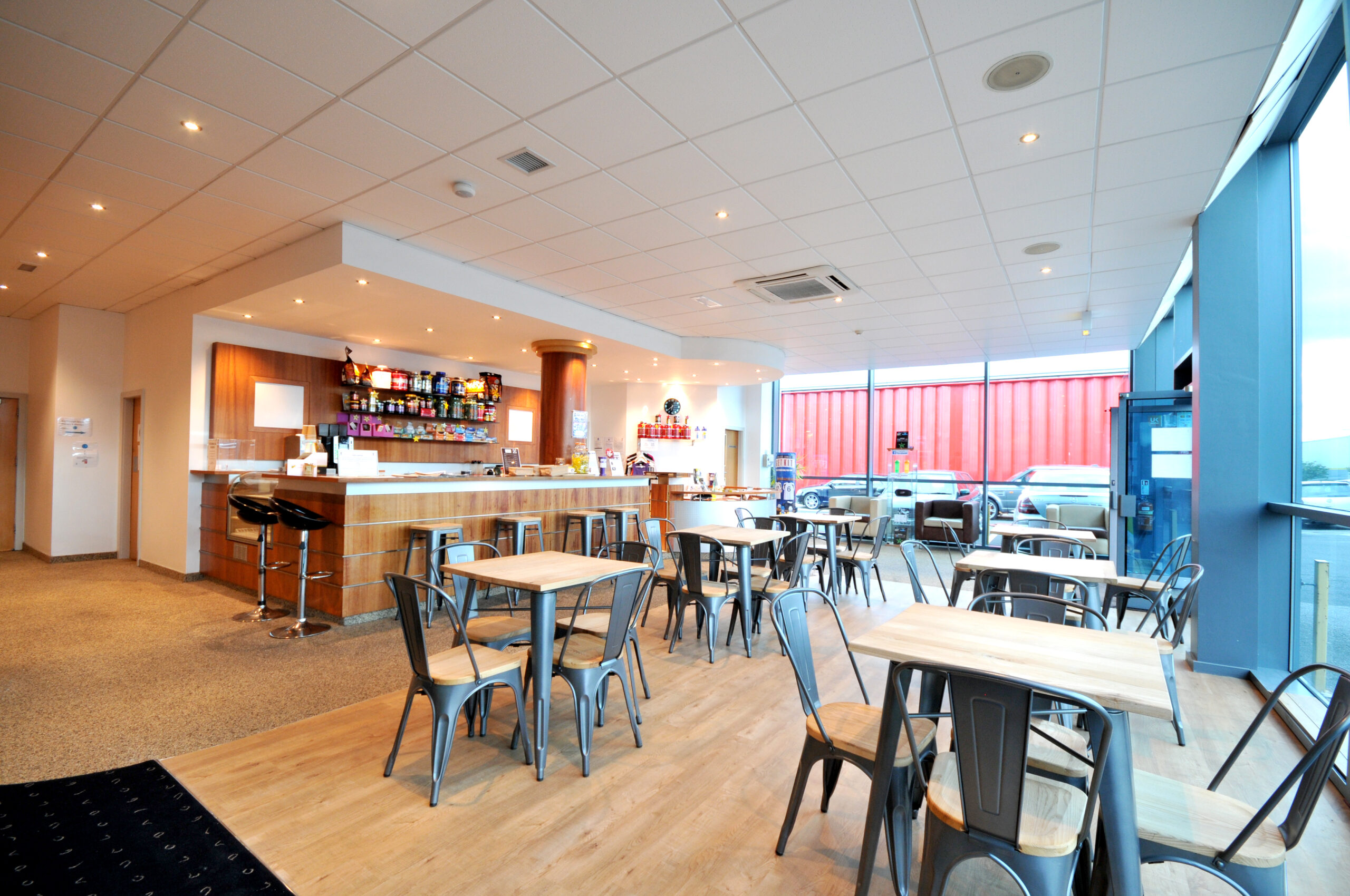 Modern cafe interior with tables and chairs.
