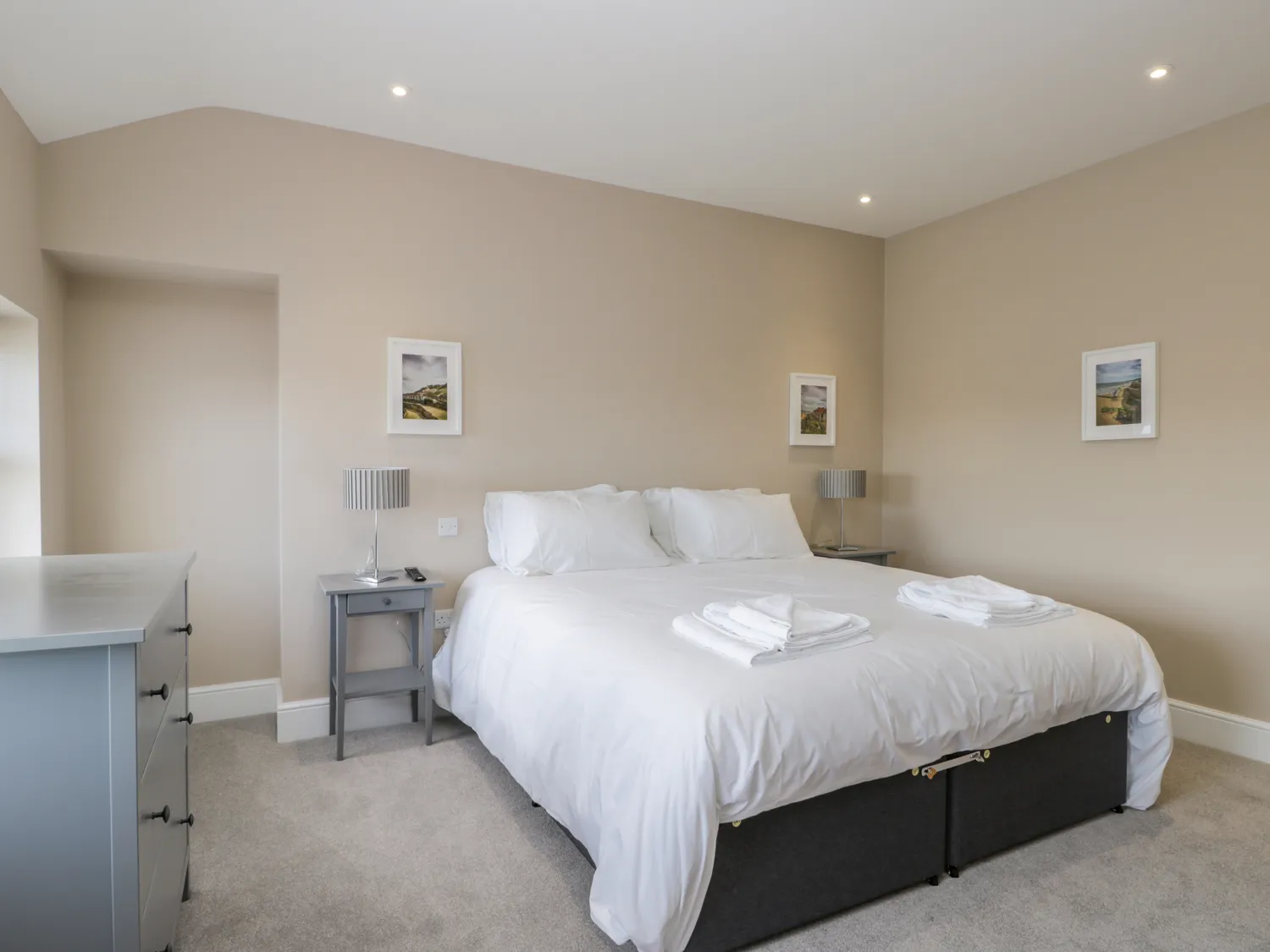 Modern bedroom with double bed and bedside tables.