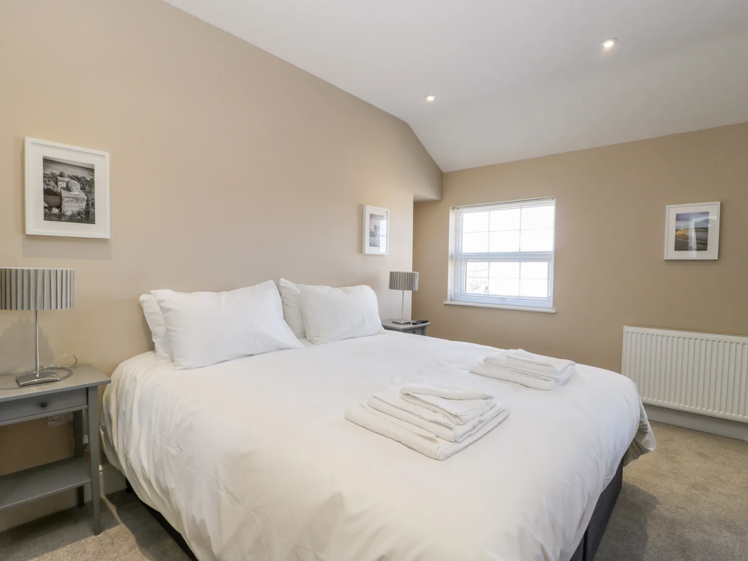 Comfortable bedroom with double bed, neutral decor