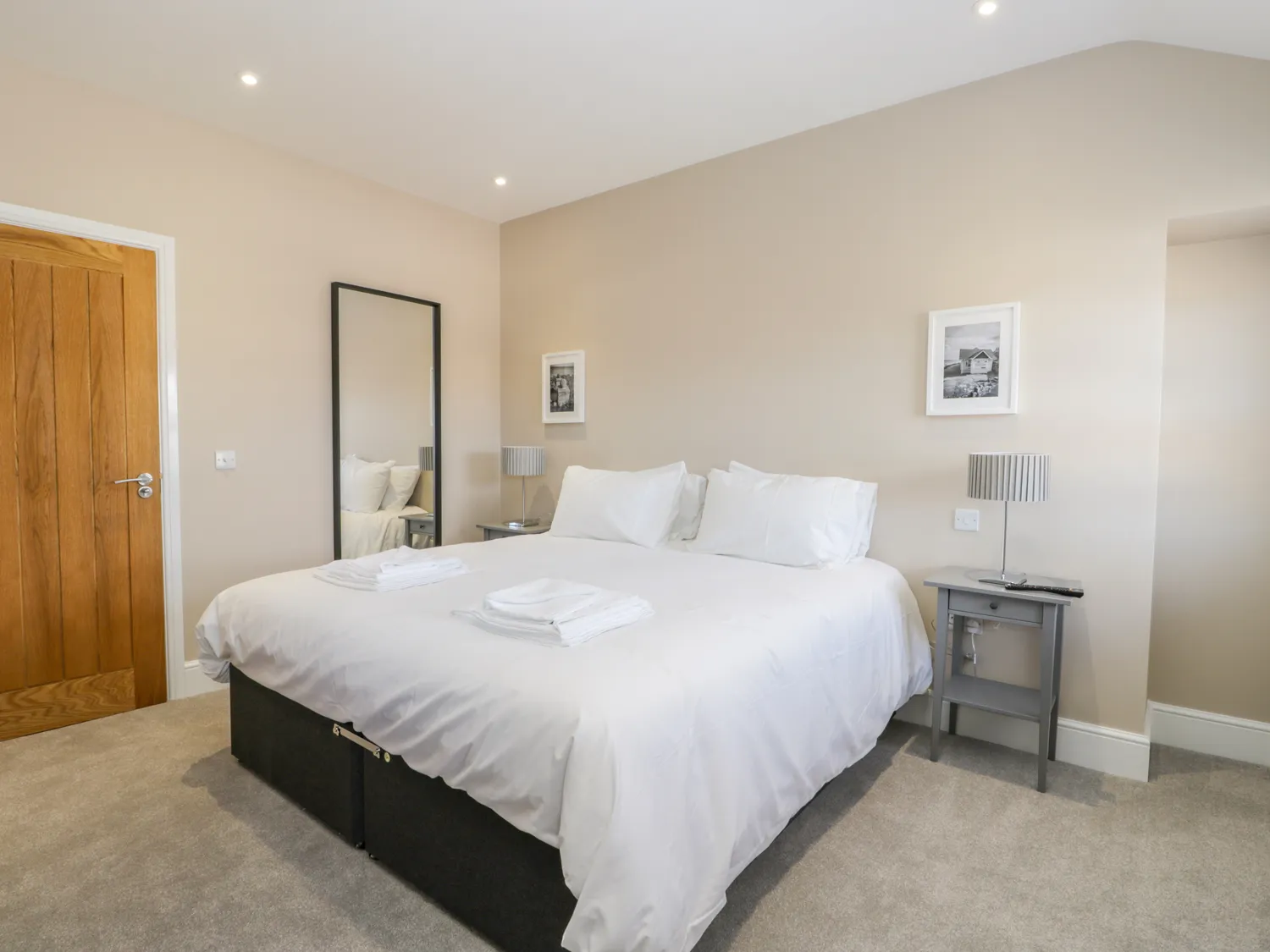 Spacious bedroom with king-size bed and modern decor.