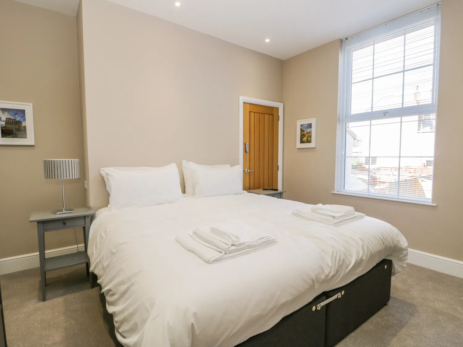 Cosy double bedroom with modern decor and natural light.
