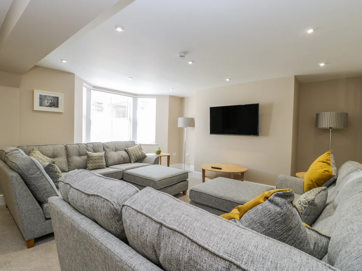Modern living room with grey sofas and TV.