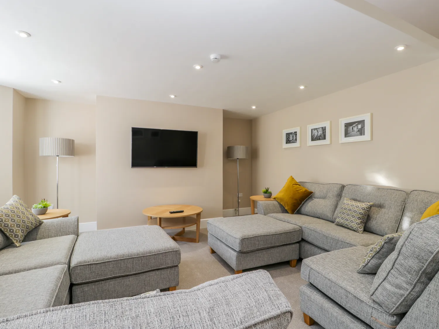 Modern living room with grey sofas and TV.