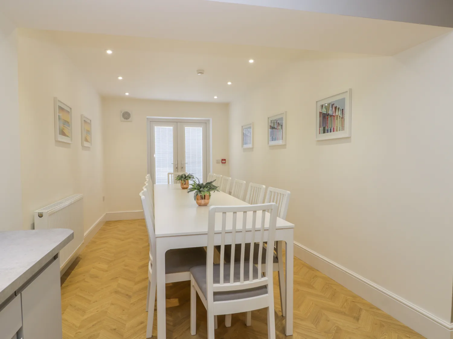 Modern dining room with white table and chairs.