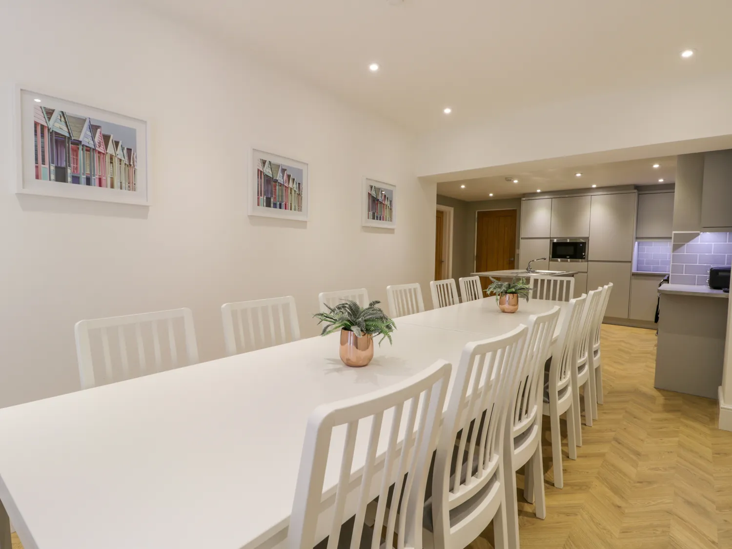 Spacious modern dining room with long table.