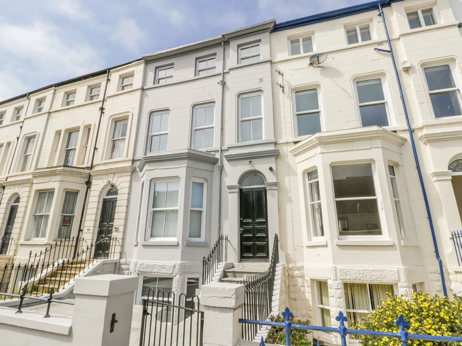 Victorian terraced houses, white stone, sunny day.