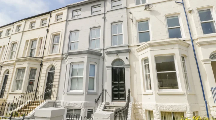 Row of Victorian terraced houses with steps.