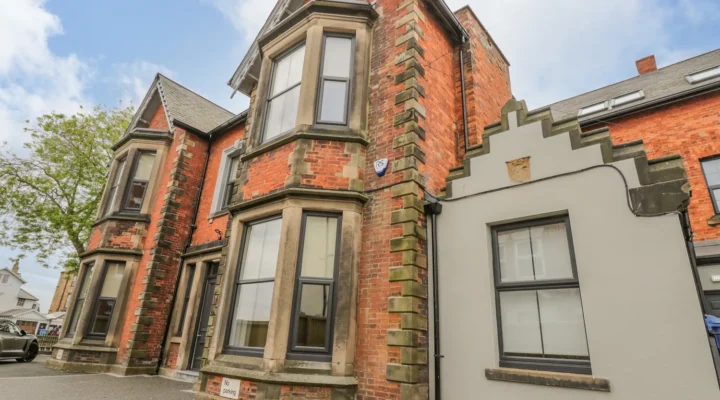 Victorian building with bay windows and brick facade.